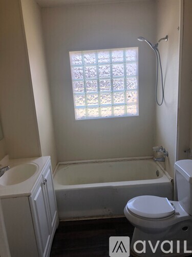 A bathroom with a toilet, sink, and bathtub.
