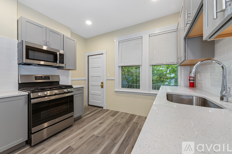 A kitchen with a stove, oven, and sink.