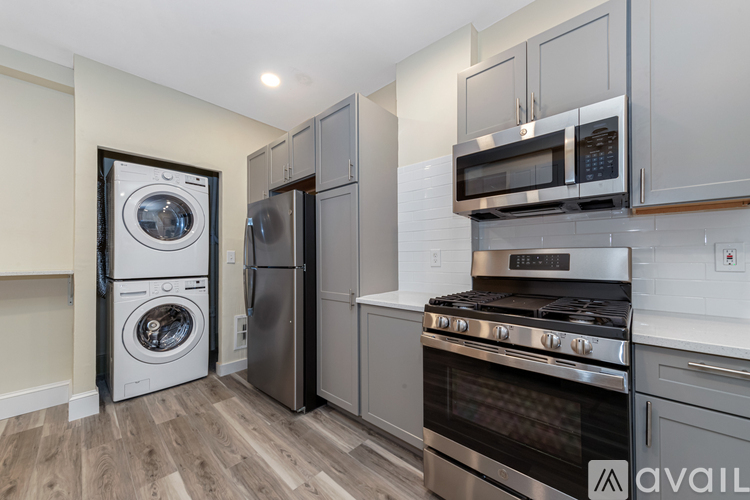 A kitchen with a stove, oven, and microwave.