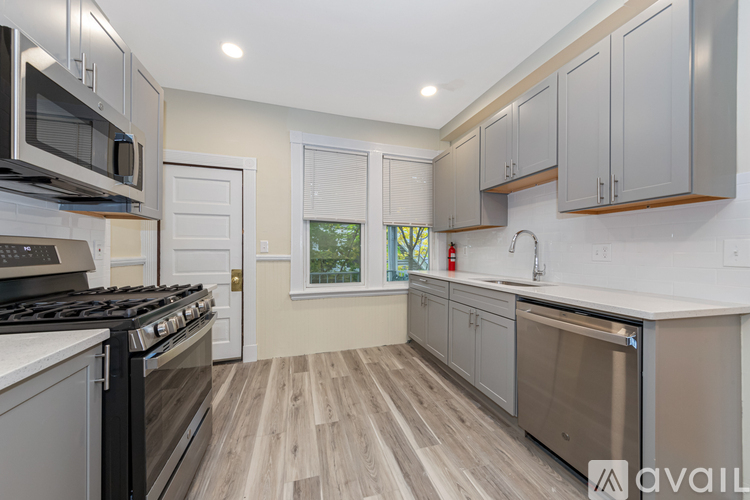 A kitchen with a stove top oven and a dishwasher.