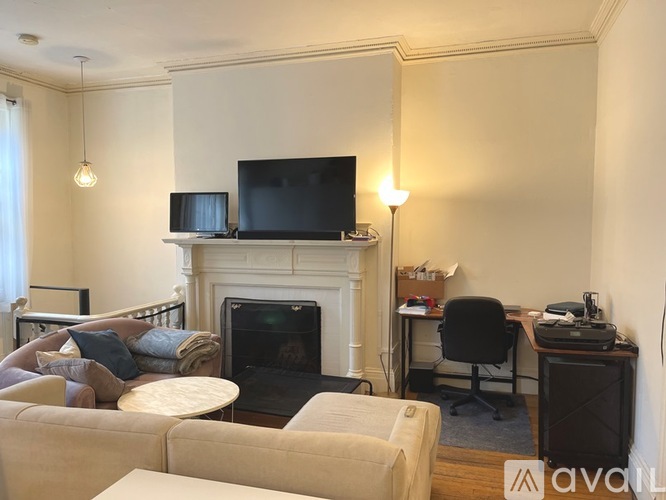 A living room with a fireplace and a television on top of it.