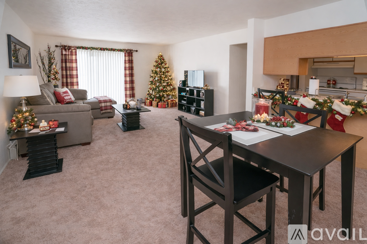 A living room with a Christmas tree and decorations.