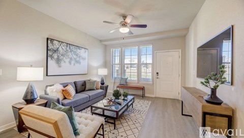 A living room with a couch, coffee table, and a painting on the wall.