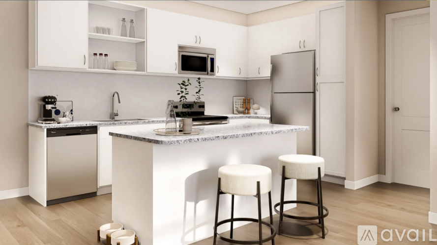 A kitchen with white cabinets and a marble countertop.