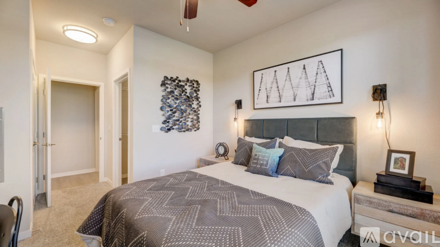 A bedroom with a large bed and a ceiling fan.