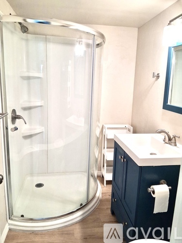A kitchen with a white fridge, sink, and cabinets.