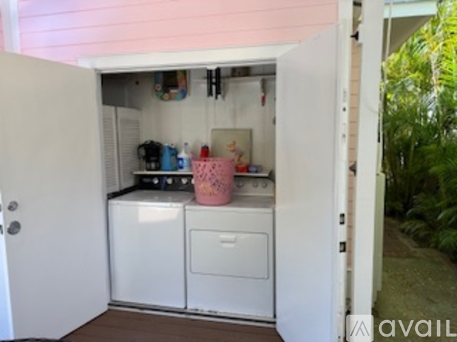 A small kitchen with a washing machine and a dishwasher.