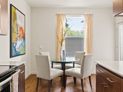 A dining room with a glass table and chairs.