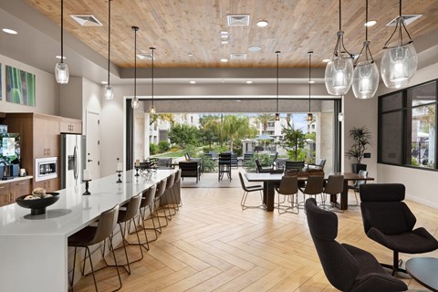 A modern dining room with a long table and chairs.