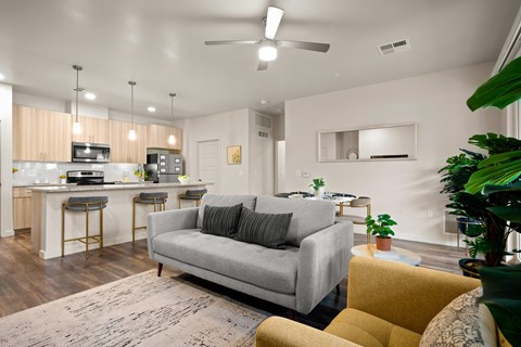 A living room with a grey couch and a yellow chair.