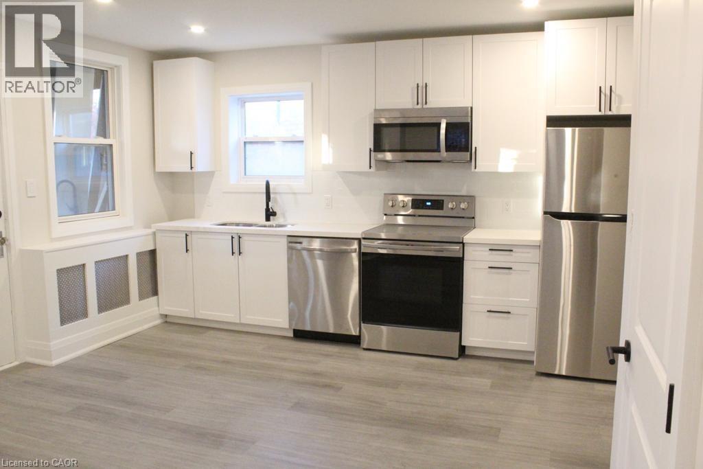 A modern kitchen with stainless steel appliances and white cabinets.