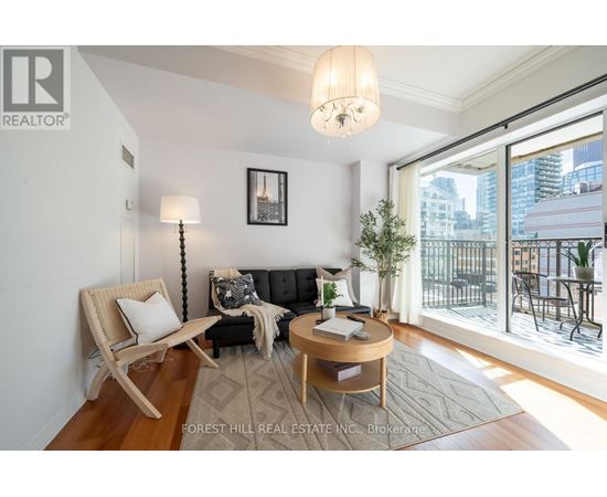 A living room with a couch, chair, and a table with a plant on it.