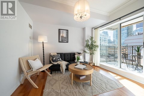 A living room with a couch, chair, and a table with a plant on it.