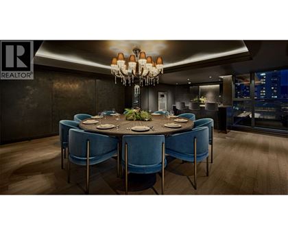 A dining room with a round table and blue chairs.