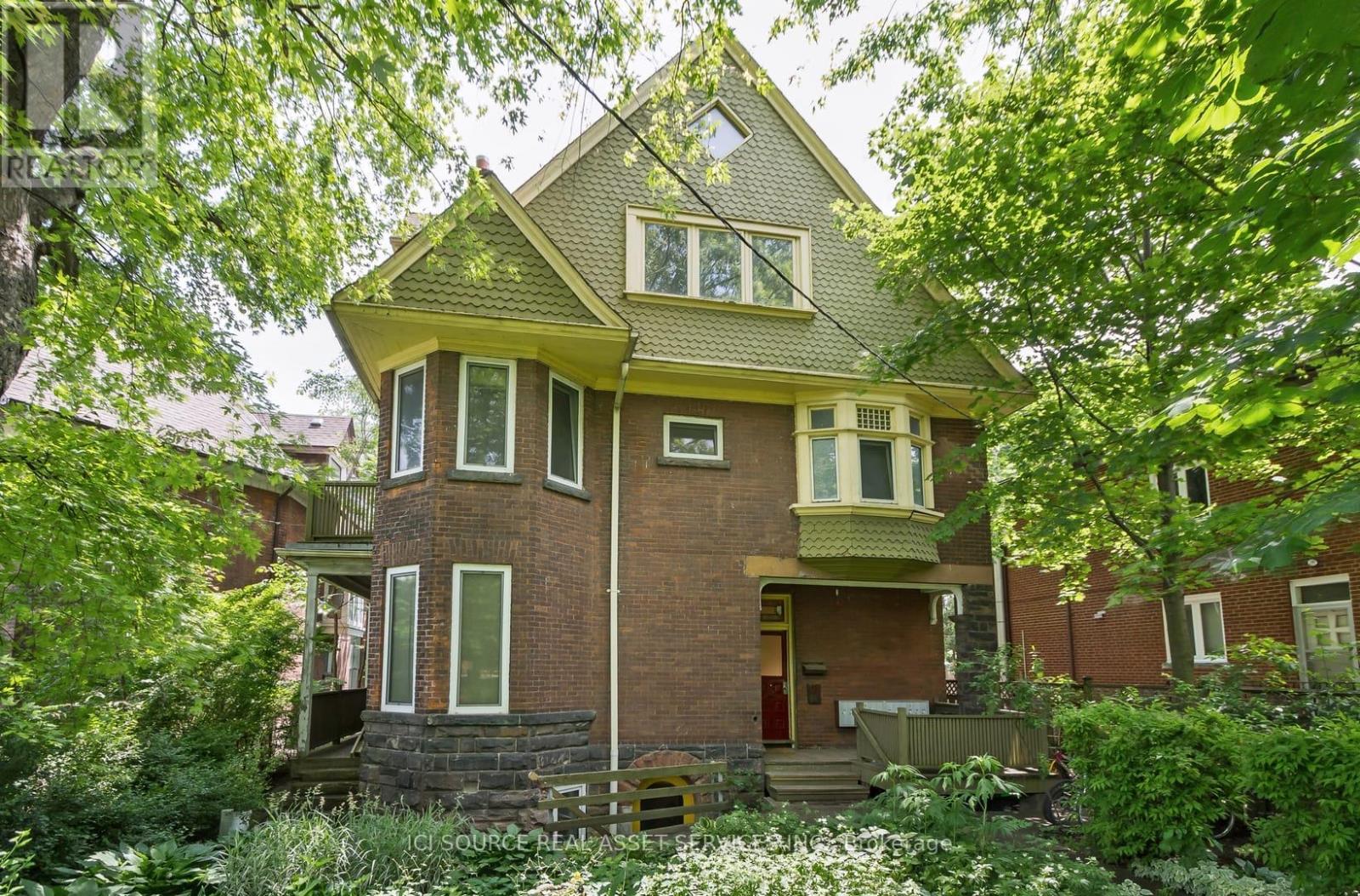 A house with a red door and a green roof.