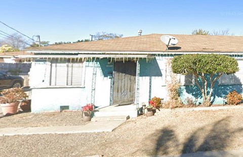A house with a blue and white exterior and a brown roof.