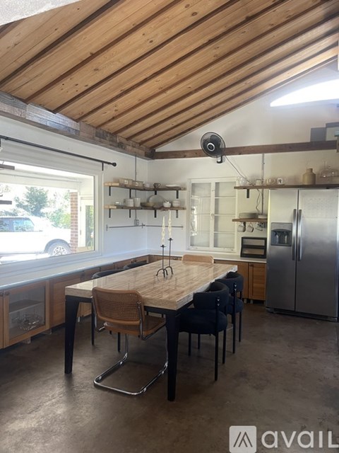 A kitchen with a table and chairs in the middle of the room.