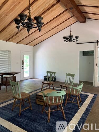 A dining room with a table and chairs.