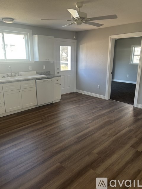 A room with wooden floors and a ceiling fan.