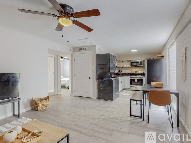A modern kitchen with a dining table and chairs.