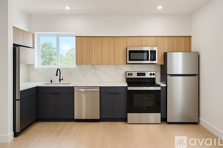 A kitchen with a black fridge, stainless steel dishwasher, and oven.
