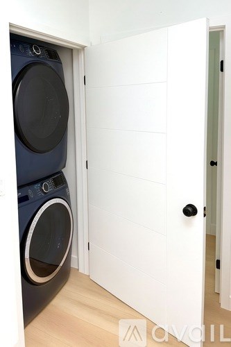 A washing machine is in a small room.
