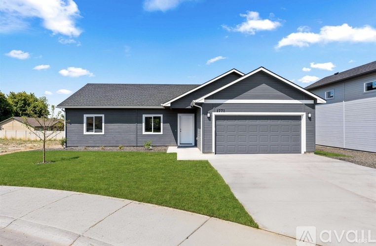 A house with a grey garage door is for sale.
