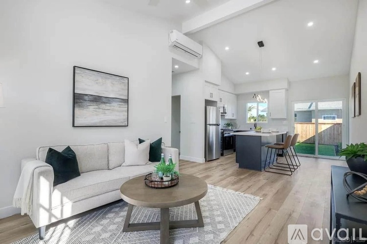 A living room with a white couch and a coffee table.