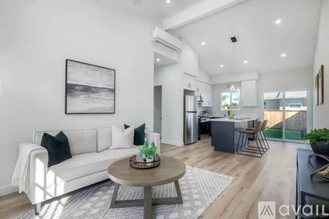 A living room with a white couch and a coffee table.