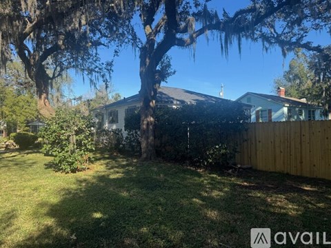 A house with a tree in front of it.
