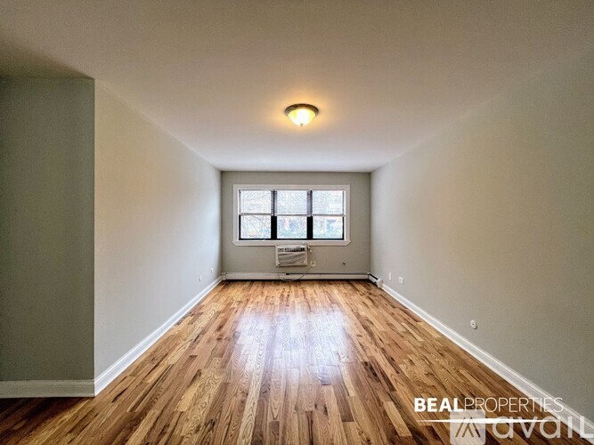 A room with wooden floors and a window.