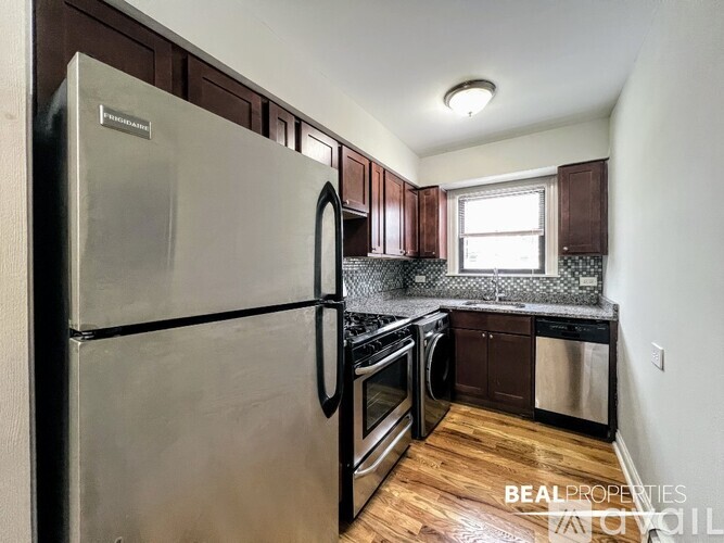 A kitchen with a stainless steel refrigerator, oven, and dishwasher.