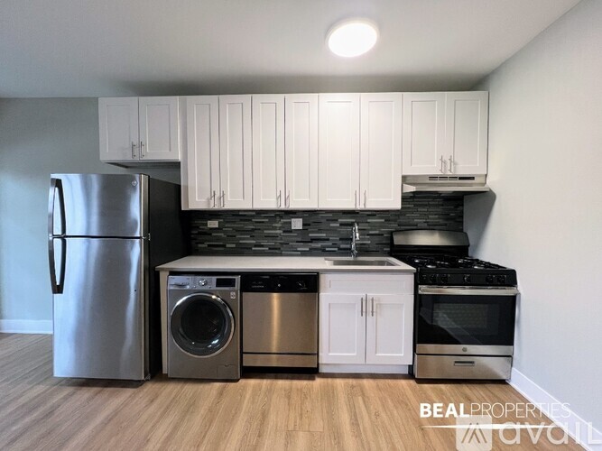 A kitchen with a stainless steel refrigerator, dishwasher, and oven.