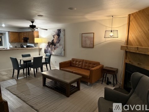 A living room with a brown couch and a wooden coffee table.