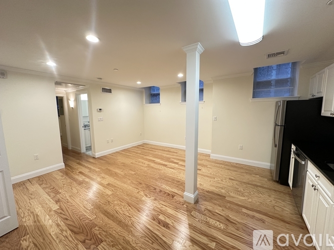 A kitchen with wooden floors and white walls.