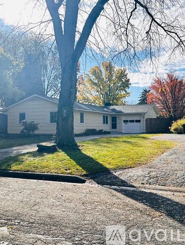 A house with a tree in front of it.