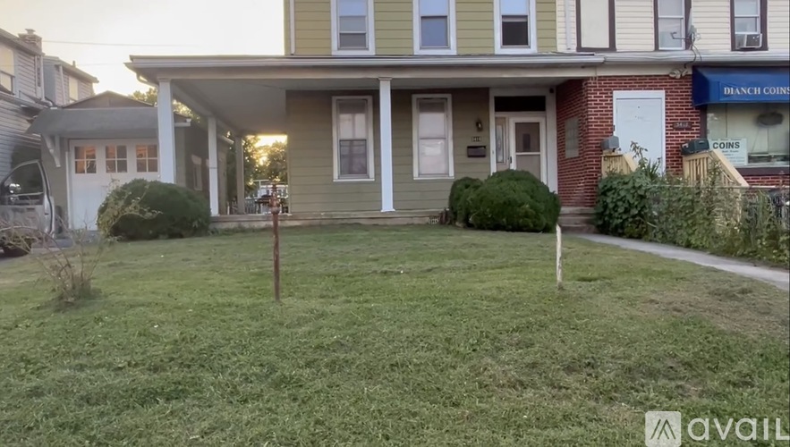 A house with a green lawn in front of it.