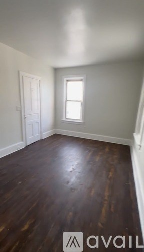 A room with wooden floors and a window.