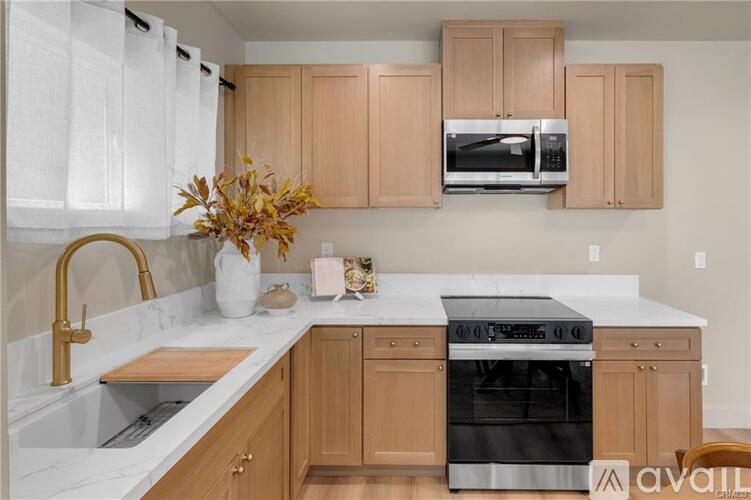 A kitchen with wooden cabinets and a black oven.