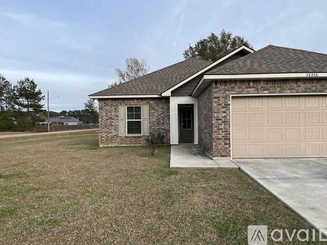 A house with a garage is available for sale.