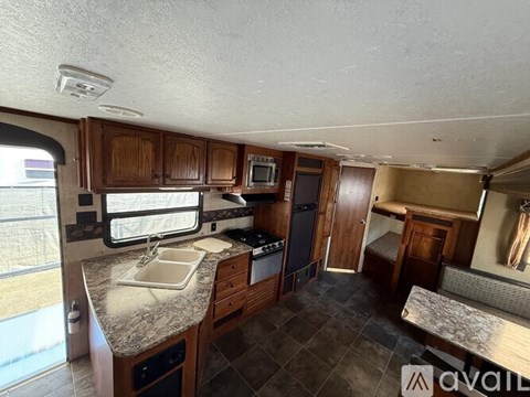 A kitchen with wooden cabinets and a granite countertop.