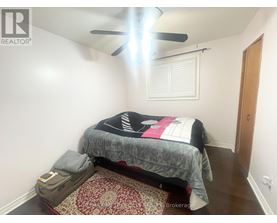 A bedroom with a bed, pillow, and a ceiling fan.