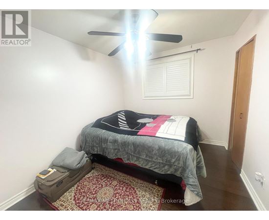 A bedroom with a bed, pillow, and a ceiling fan.