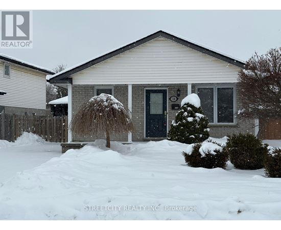 A house with a snow-covered front yard.