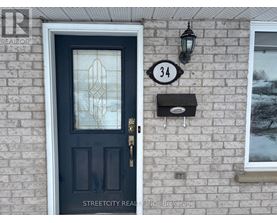 A black door with a glass window and a mailbox on a brick wall.
