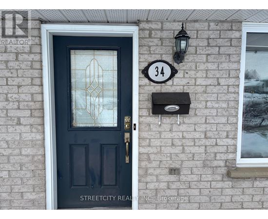 A black door with a glass window and a mailbox on a brick wall.