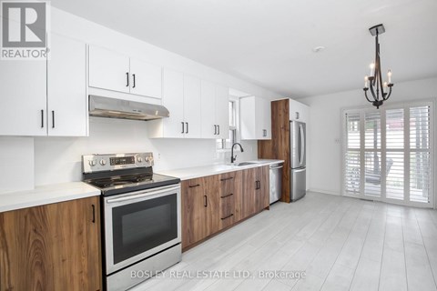 A modern kitchen with wooden cabinets and stainless steel appliances.