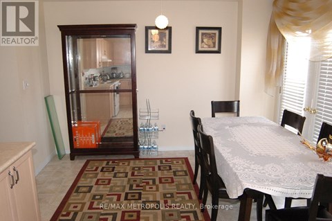 A dining room with a table set for four.