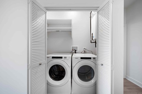 A small laundry room with a washer and dryer.