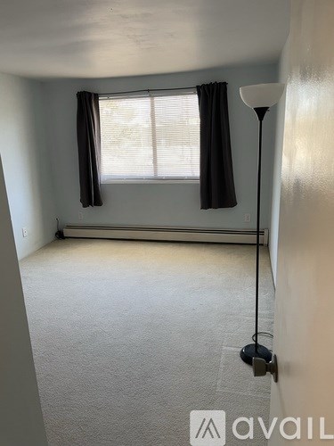 A room with a window and a lamp.